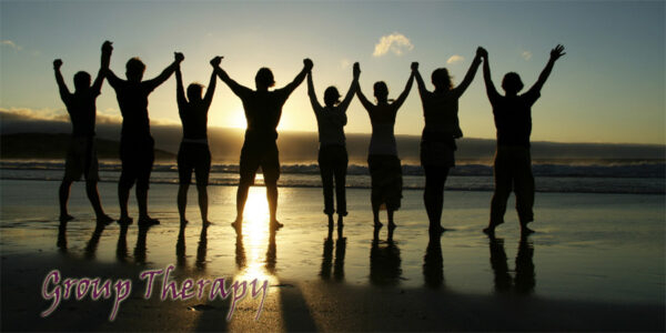 Group of people celebrating on the beach during the sunset